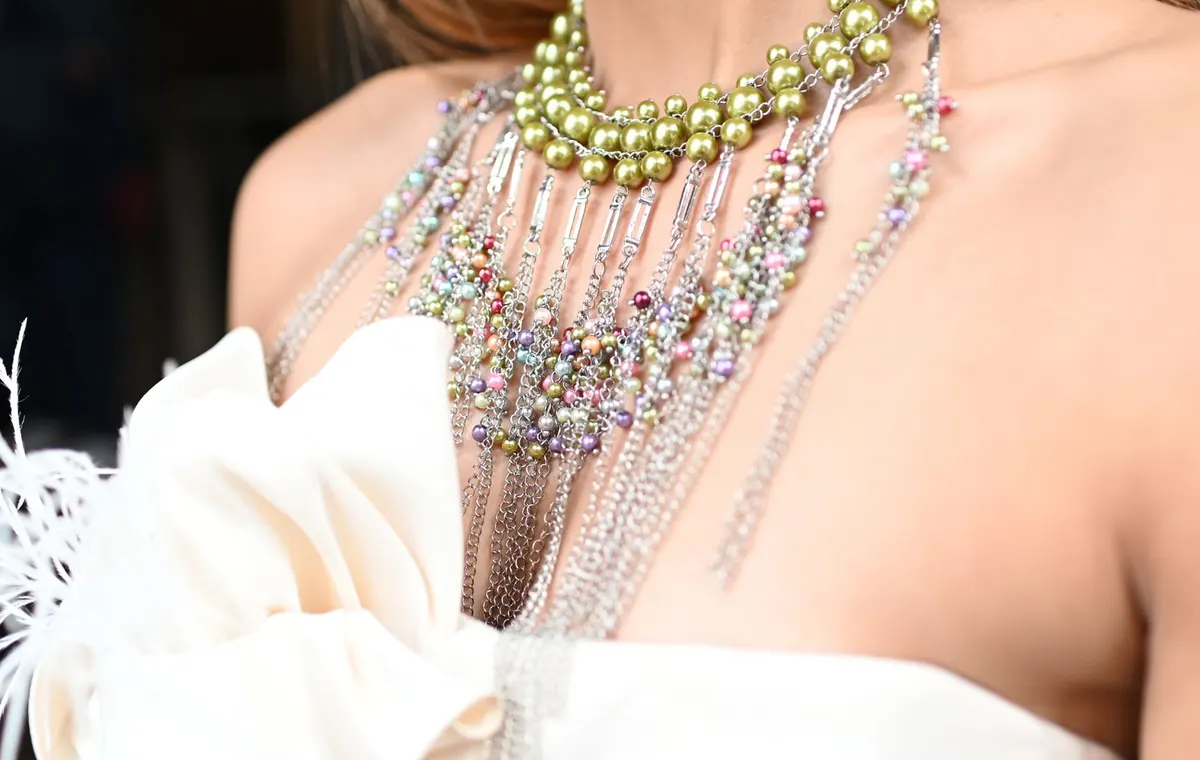 Bijoux fantaisie colorés posés sur tissu crème